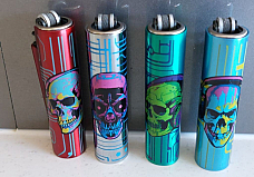 Clipper  4 x Micro  Refillable Lighters  collectable in metal skull cases
